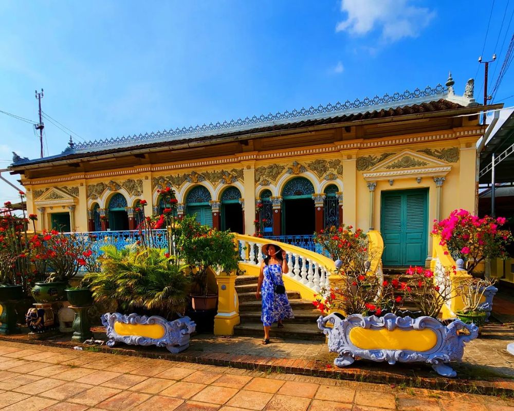 The-girl-wears-a-dress-and-takes-a-photo-at-Binh-Thuy-ancient-house