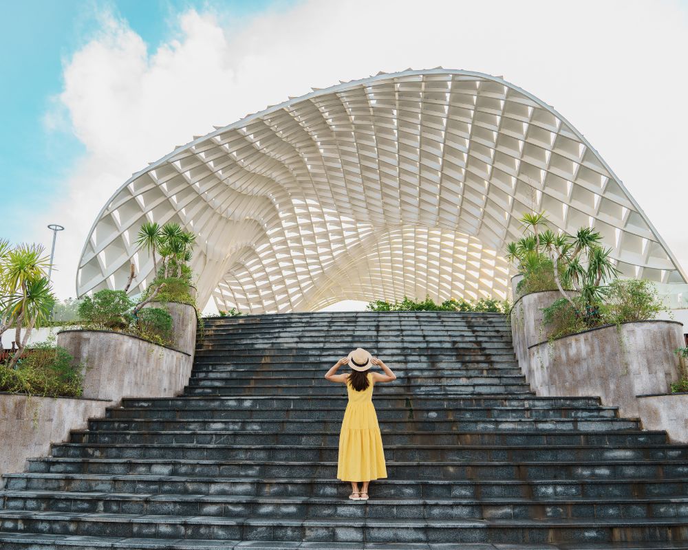 Woman-traveler-with-yellow-dress-visiting-in-da-nang-city-tourist-sightseeing-the-city-building-landmark