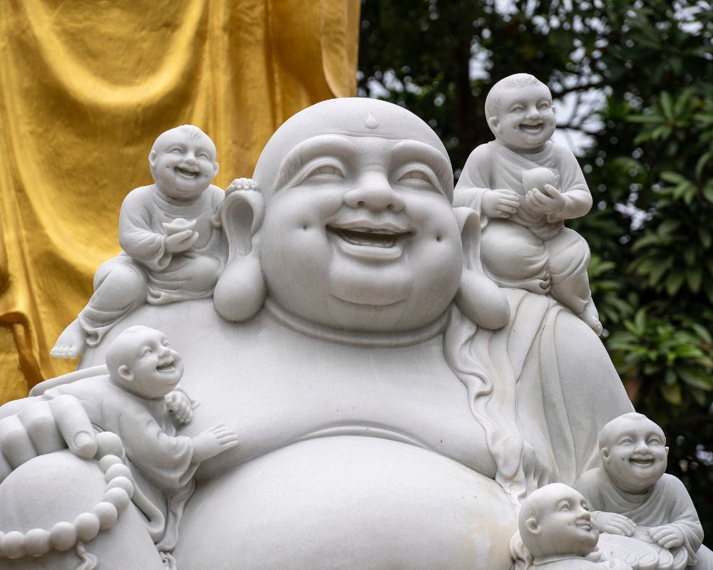 Marble-sculpture-of-a-happy-Buddha-with-children-at-a-Buddhist-temple-in-Danang-city-Vietnam