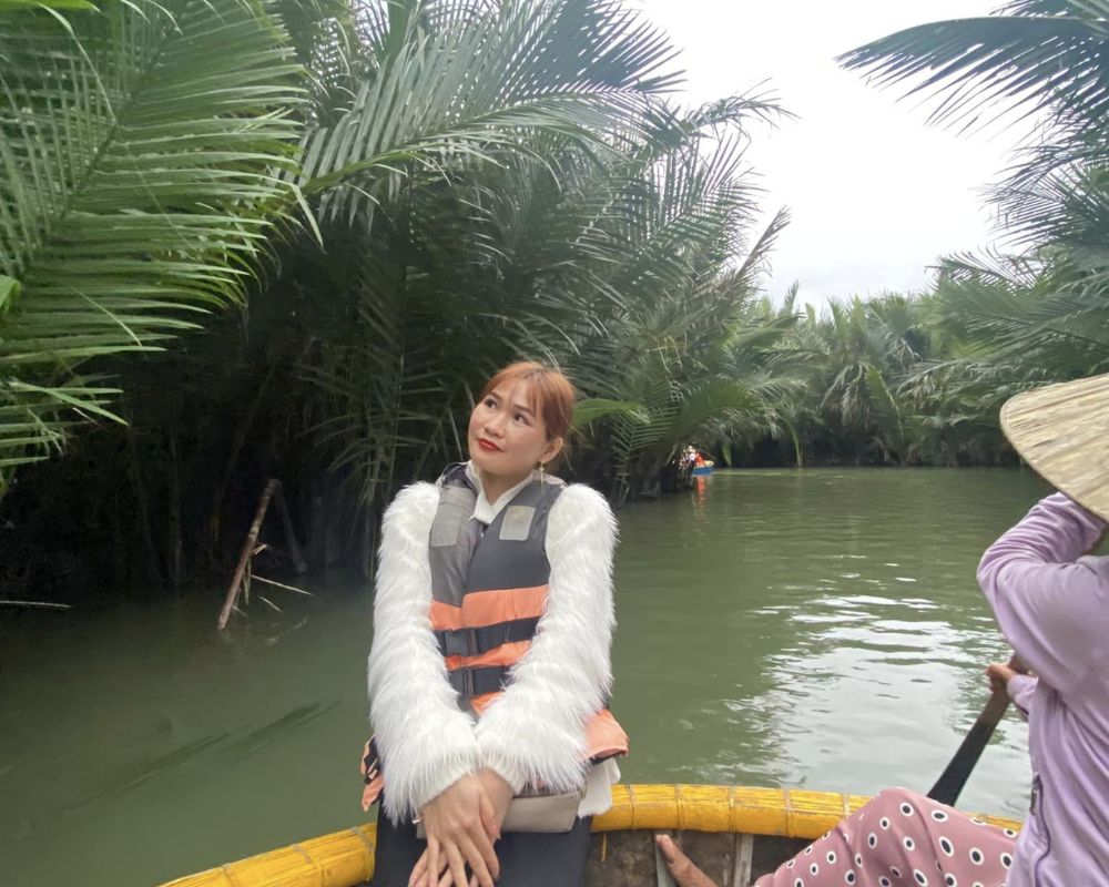 The-girl-is-sitting-on-a-basket-boat-admiring-the-beauty-of-Bay-Mau-Coconut-Forest